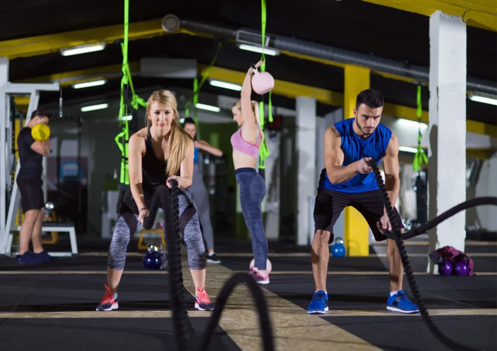 Image displaying a gym with people working out at some type of gym