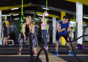 Image displaying a gym with people working out at some type of gym